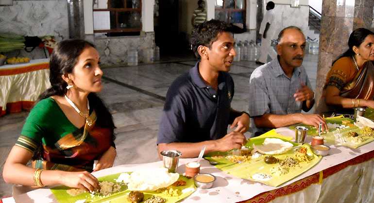 indian-family-eating-and-drinking-at-dining-table-at-home-in-the